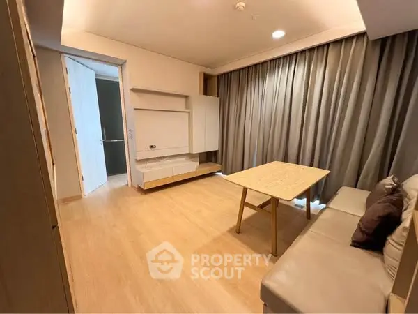 Modern living room with wooden flooring and cozy sofa in a stylish apartment.