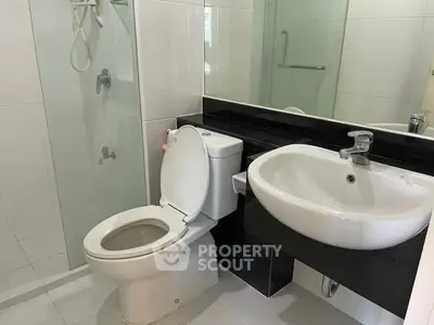 Modern bathroom with sleek fixtures and glass shower enclosure