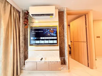 Modern living room with wall-mounted TV and air conditioning unit, elegant marble accents.