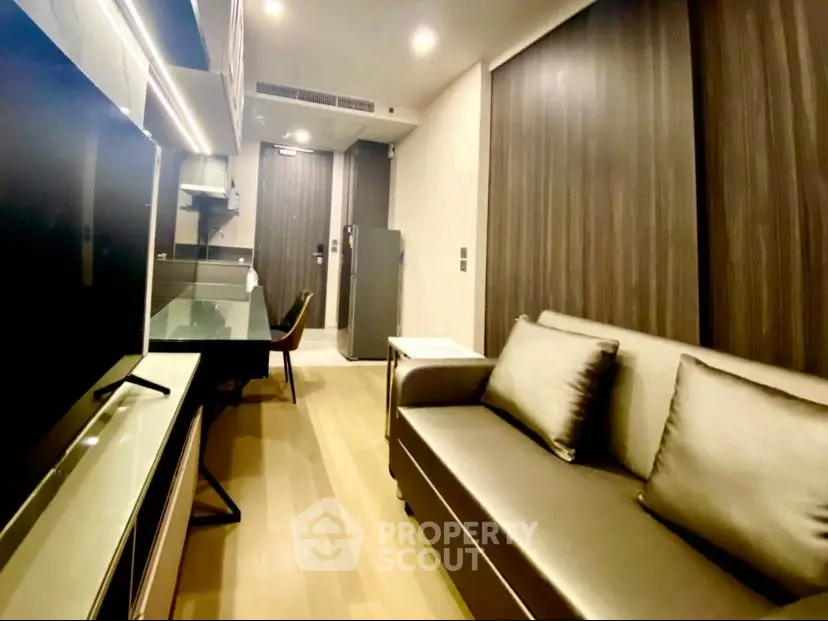 Modern living room with sleek furniture and open kitchen layout