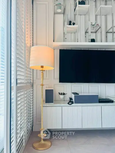 Modern living room with elegant floor lamp and sleek entertainment unit