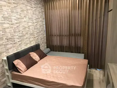 Cozy bedroom with stylish stone accent wall and elegant curtains