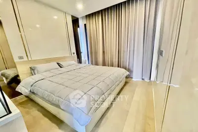 Luxurious modern bedroom with elegant decor and floor-to-ceiling curtains