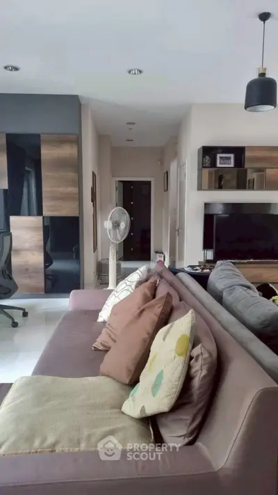 Stylish living room with modern decor and cozy seating area, perfect for relaxation and entertainment.