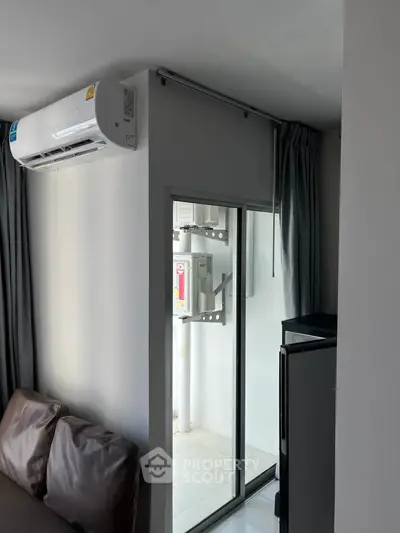 Modern apartment with air conditioning and sliding glass door to balcony