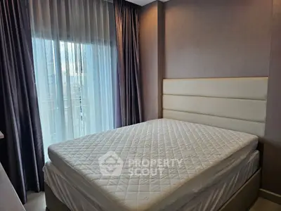 Modern bedroom with large window and elegant curtains