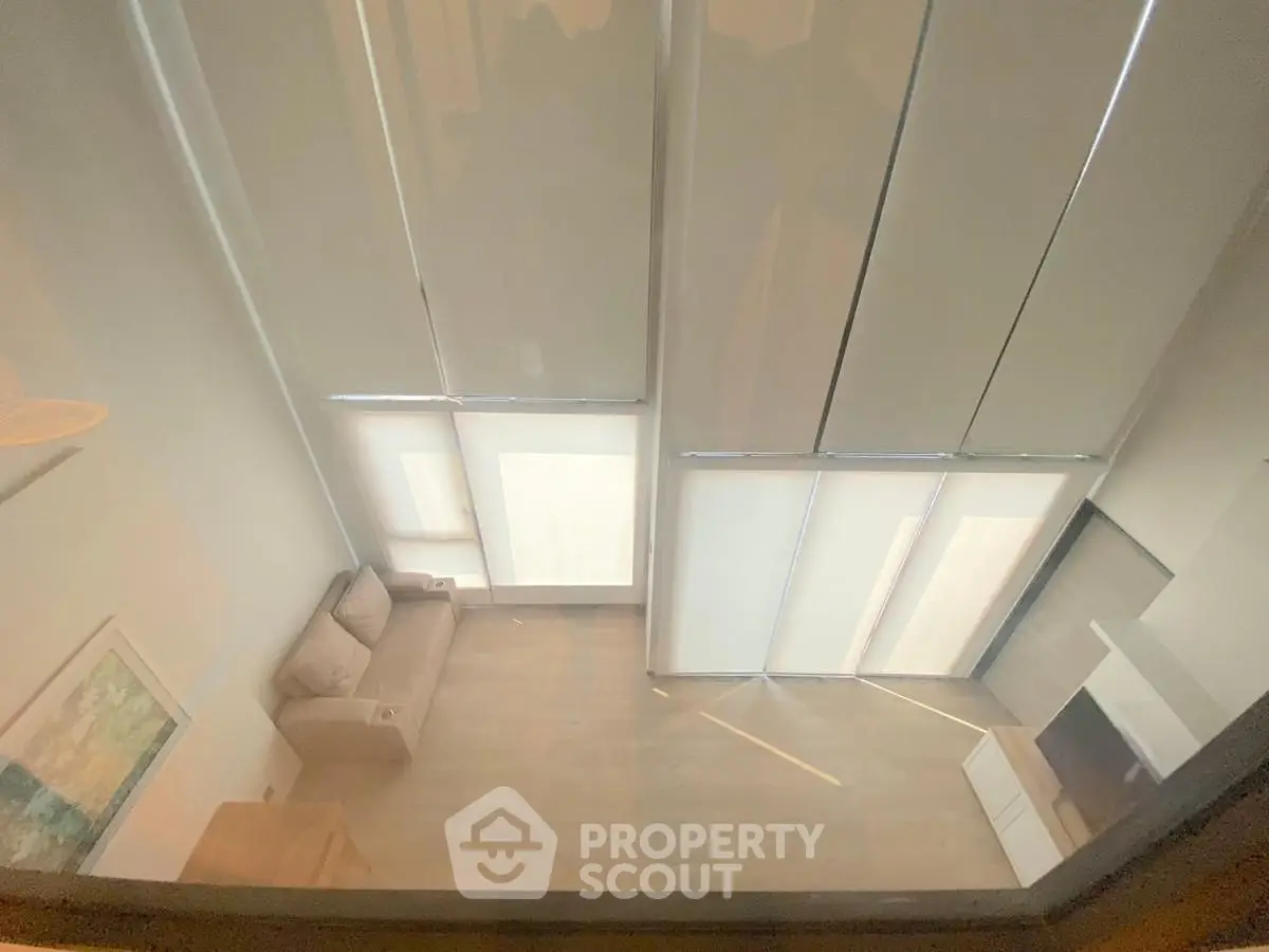 Modern living room with high ceilings and large windows