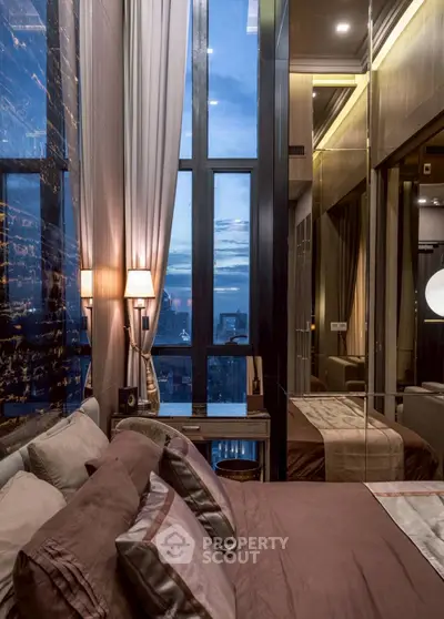 Luxurious bedroom with floor-to-ceiling windows offering stunning city views.