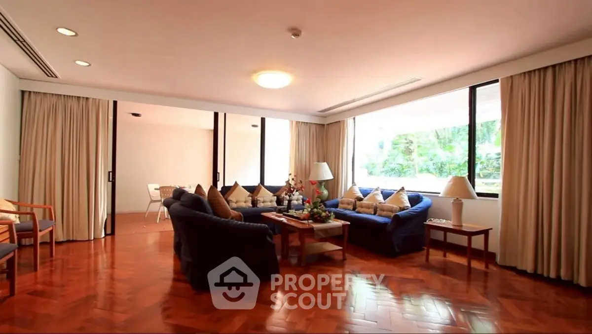 Spacious living room with elegant wooden flooring and large windows