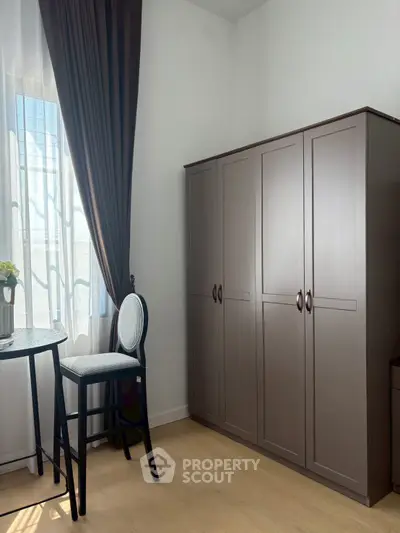 Stylish bedroom corner with elegant wardrobe and natural light