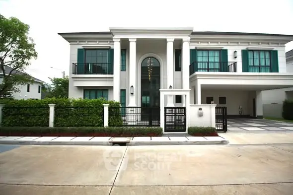 Elegant modern house with grand entrance and lush greenery