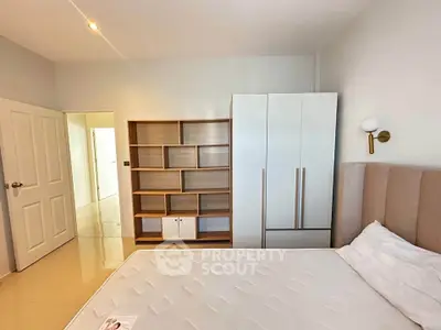 Spacious bedroom with modern furniture and ample storage space