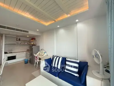 Modern living room with blue sofa and open kitchen layout