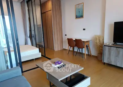 Modern studio apartment with stylish furniture and open layout in a high-rise building.