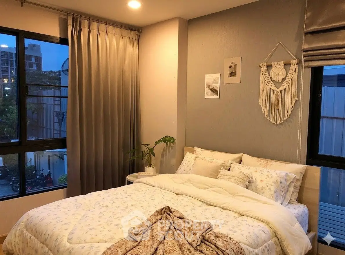 Cozy bedroom with elegant decor and large windows offering a serene view, perfect for relaxation and comfort.