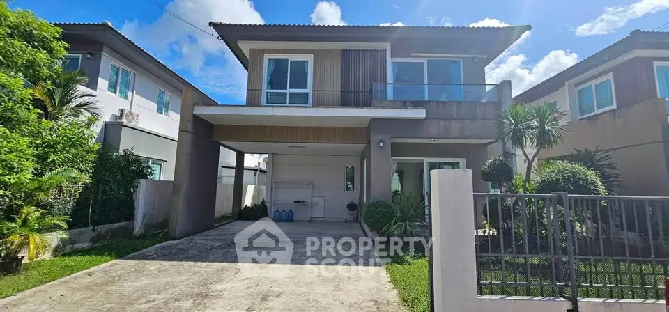Modern two-story house with spacious driveway and lush garden