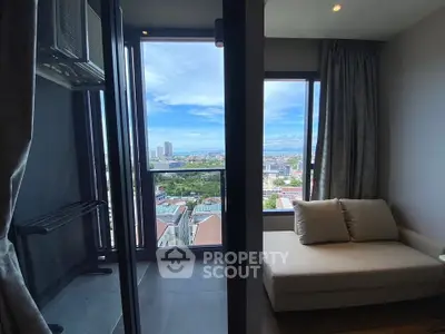 Modern apartment with stunning city view and cozy seating area