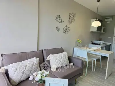Chic modern living room with cozy sofa and stylish dining area in open-plan apartment.