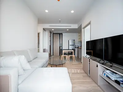 Modern open-plan living room with sleek furniture and dining area