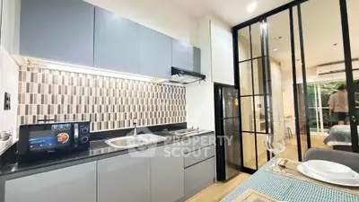Modern kitchen with sleek cabinetry and open layout in stylish apartment