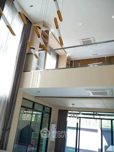 Elegant modern living room with high ceilings and stylish lighting fixtures.