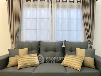 Elegant living room with stylish grey sofa and decorative pillows.