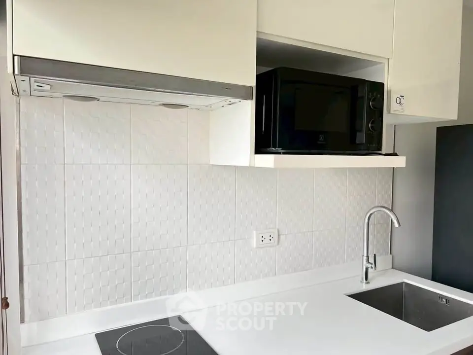 Modern kitchen with sleek white cabinetry and built-in appliances
