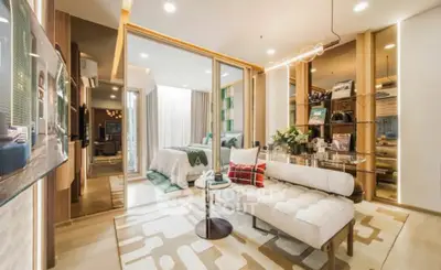 Luxurious modern living room with elegant decor and open layout, featuring a cozy bedroom view.