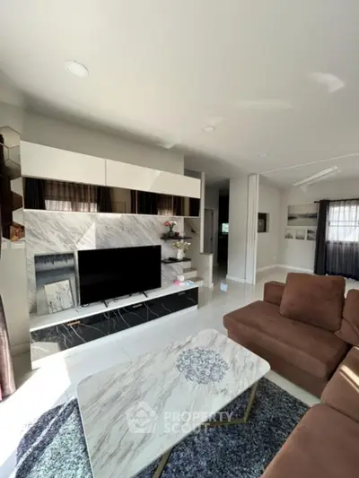 Modern living room with stylish marble accents and cozy brown sofa