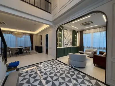 Luxurious open-plan living room with elegant marble accents and modern furnishings