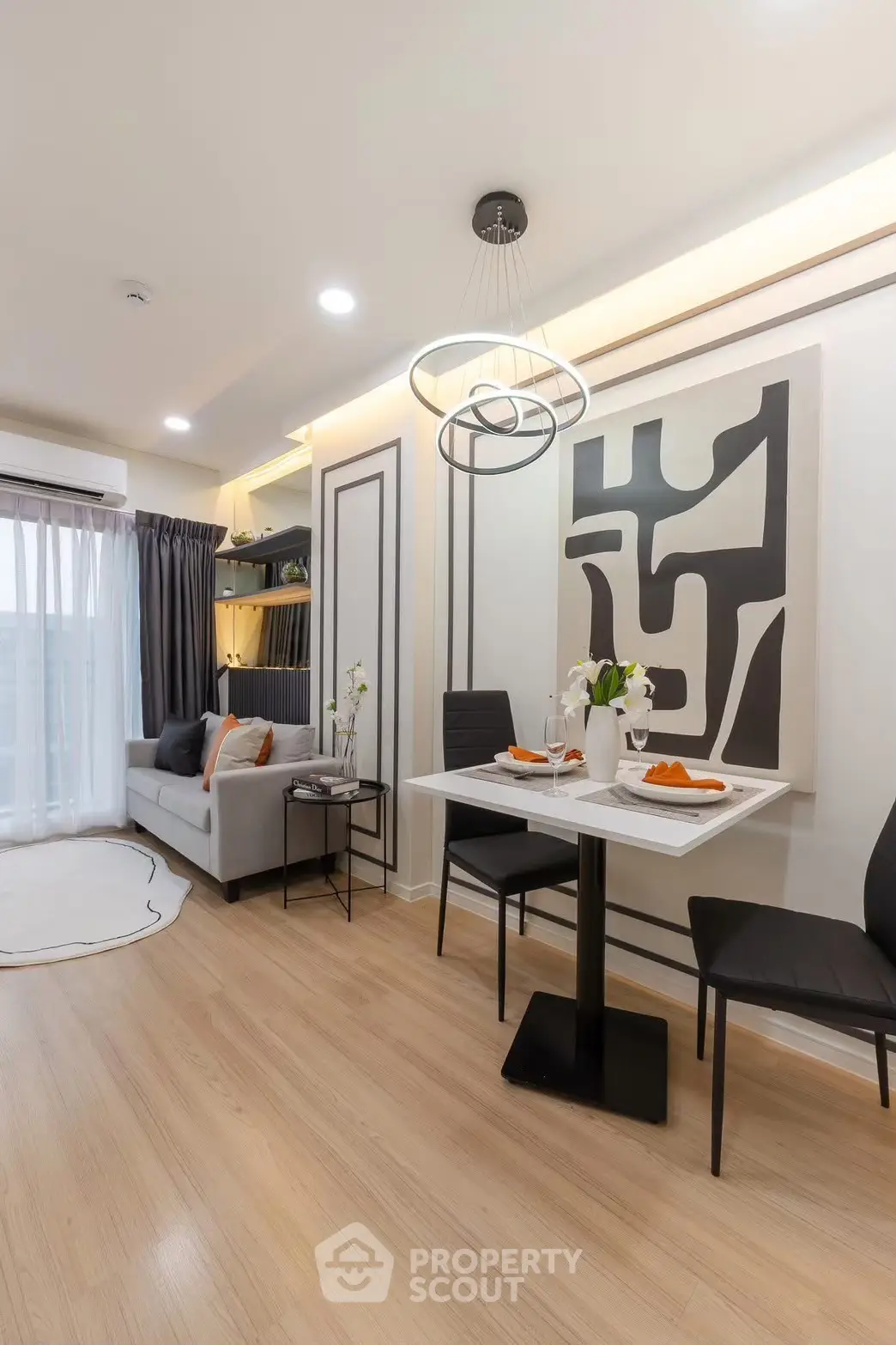 Modern living room with stylish decor and dining area in a bright apartment