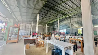 Spacious industrial-style open space with high ceilings and diverse seating options.
