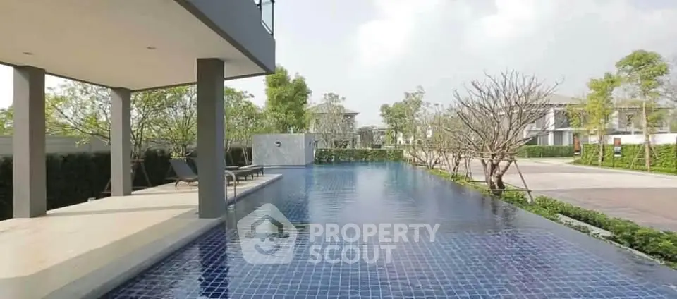 Luxurious outdoor pool area with modern design and lush greenery