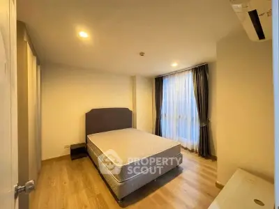 Spacious bedroom with natural light and modern decor