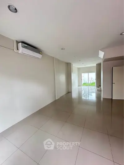 Spacious unfurnished room with tiled flooring and air conditioning, ideal for customization.