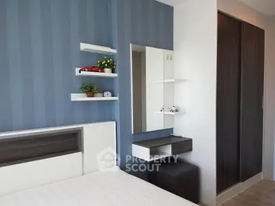 Modern bedroom with sleek design, featuring built-in wardrobe and stylish decor.