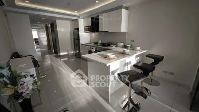 Modern kitchen with sleek design and island seating in a contemporary apartment.