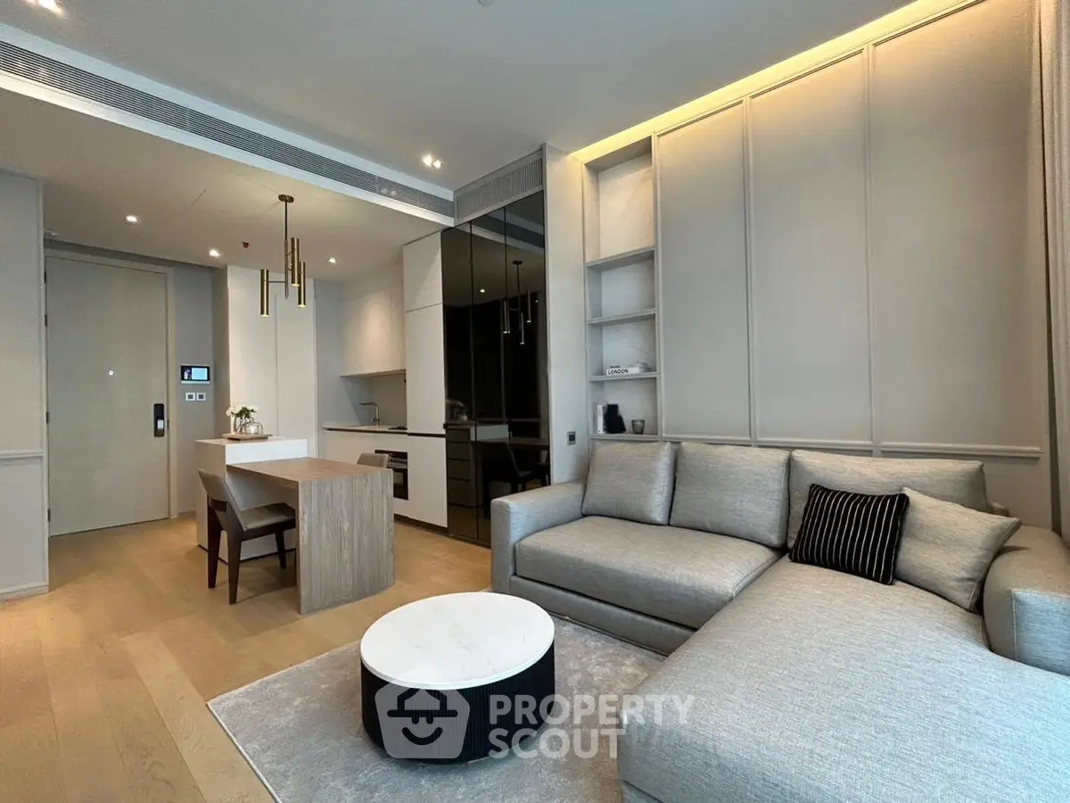 Modern living room with sleek furniture and open kitchen layout