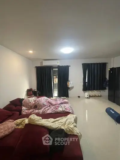 Spacious living room with modern decor and large windows for natural light.