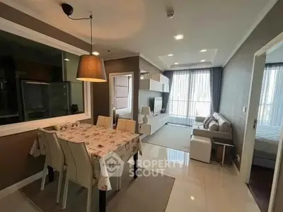 Modern open-plan living and dining area with stylish decor and natural light.