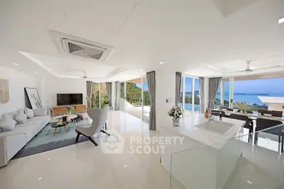 Luxurious open-plan living room with panoramic ocean views and modern decor