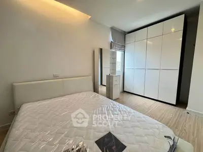 Modern bedroom with sleek white wardrobe and natural light