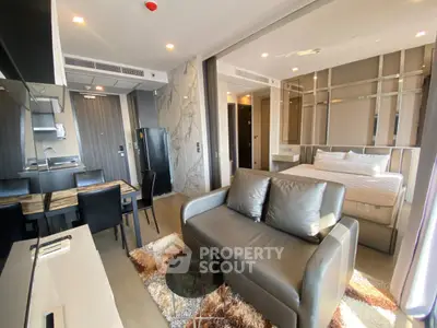 Modern studio apartment with open layout, featuring a cozy living area and stylish kitchen.