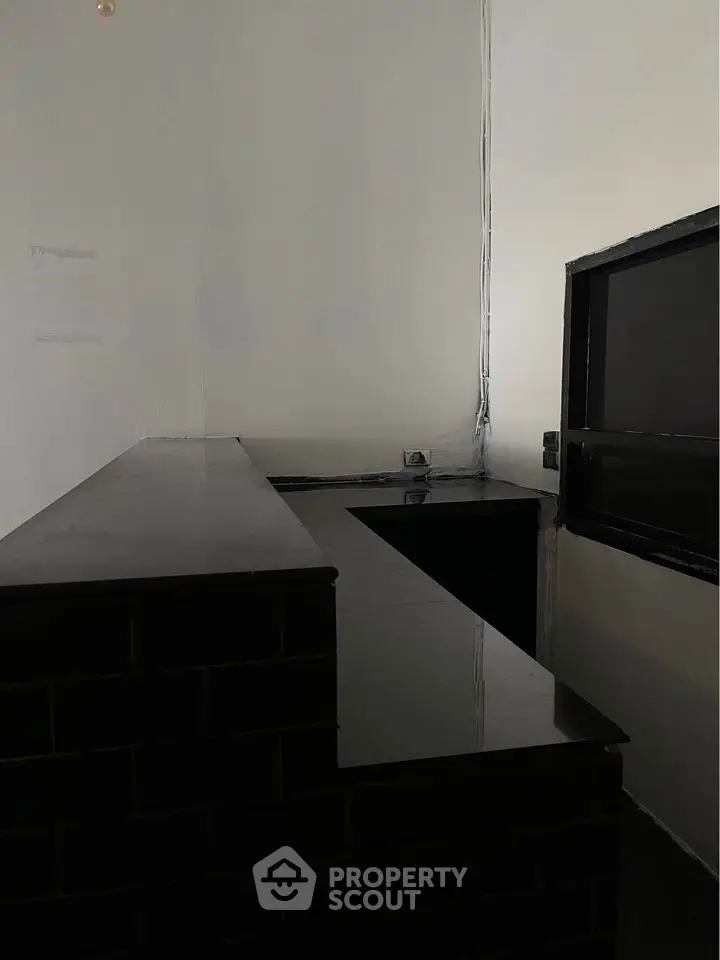 Modern minimalist kitchen with sleek black countertops and open layout