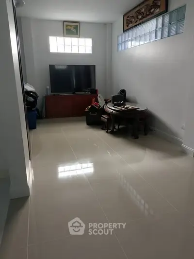 Spacious living room with modern TV setup and elegant decor