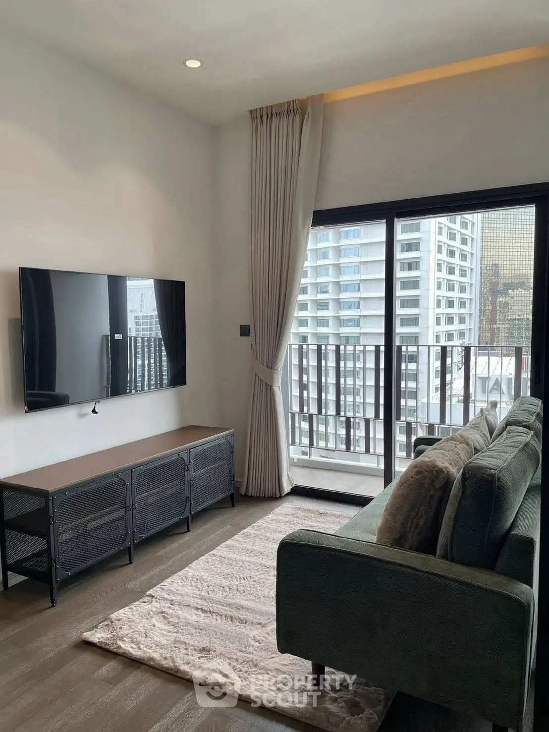 Modern living room with balcony view in high-rise apartment
