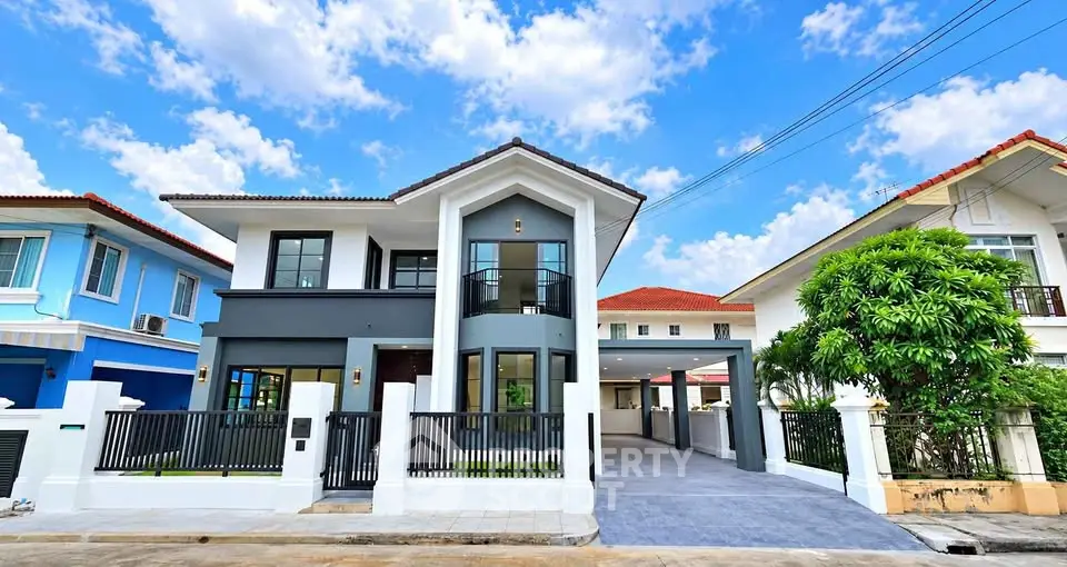 Stunning modern two-story house with sleek design and spacious driveway in a serene neighborhood.