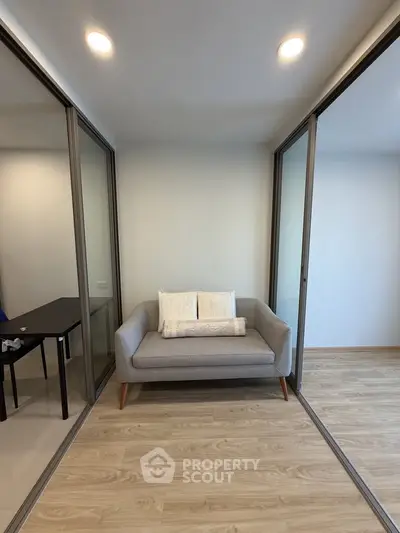 Modern minimalist study room with glass partitions and cozy sofa