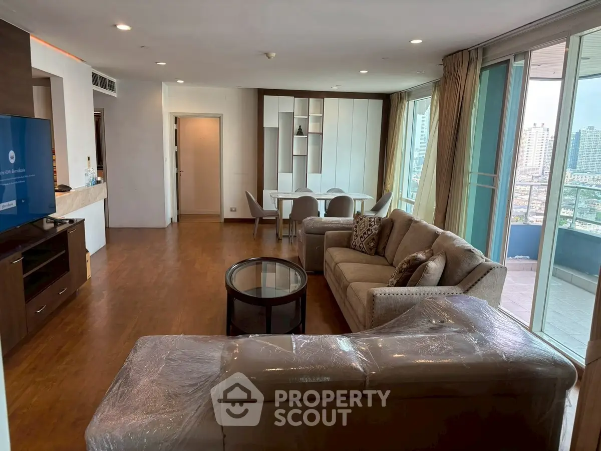 Spacious living room with modern furniture and city view balcony in luxury apartment