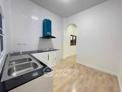 Modern kitchen with sleek countertops and dual sink in a bright, open layout.